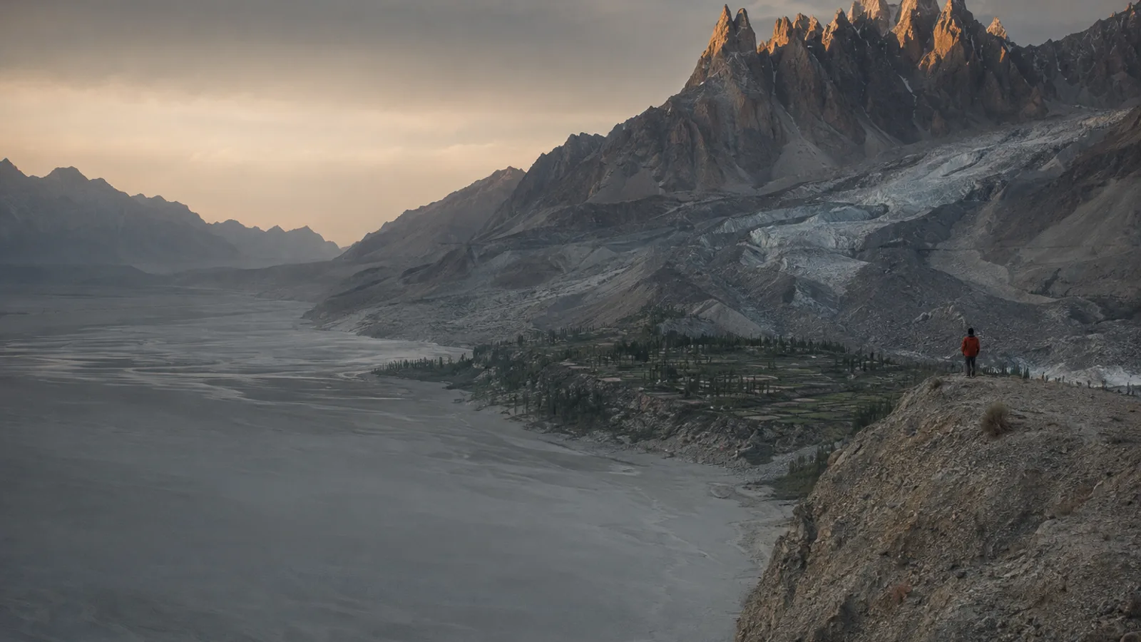 The Passu and Batura glaciers sweeping down towards the braided river below the Passu Cones in late summer light.