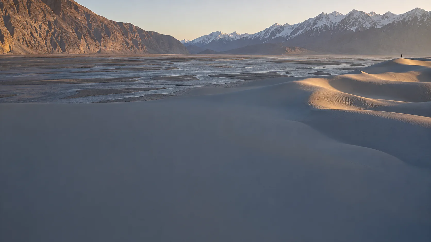 Sand dunes of the Katpana cold desert outside Skardu, with the braided Indus and the Karakoram skyline beyond.